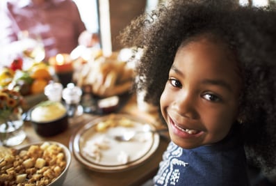 Young girl smiling at Thanksgiving Table