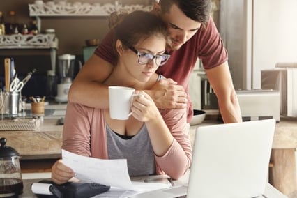 Couple looks over computer 